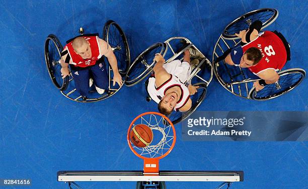 Players wait for a rebound during the Bronze Medal Wheelchair Basketball match between the United States and Great Britain at the National Indoor...