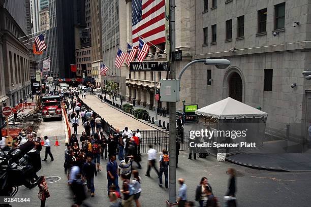 Pedestrians walk outside of the New York Stock Exchange September 16, 2008 in New York City. U.S. Stocks continued to drop Tuesday morning for the...