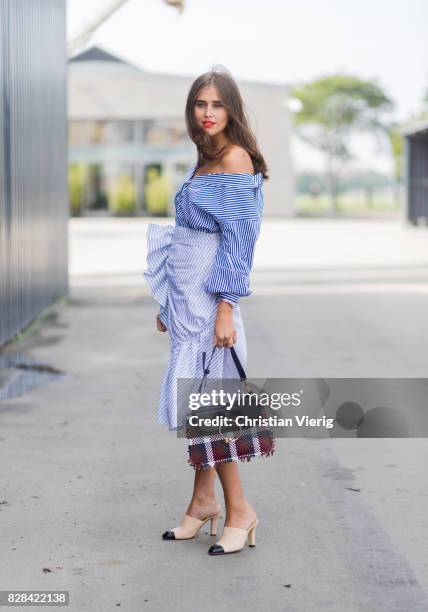 Tine Andrea and Darja Barannik wearing blue button shirts, leather pant, skirt outside By Malene Birger on August 09, 2017 in Copenhagen, Denmark.