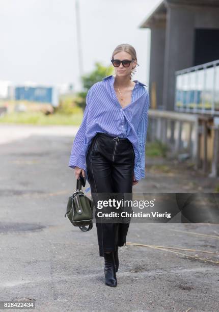 Tine Andrea wearing blue button shirt, high waisted leather pants, black boots, Loewe bag outside By Malene Birger on August 09, 2017 in Copenhagen,...