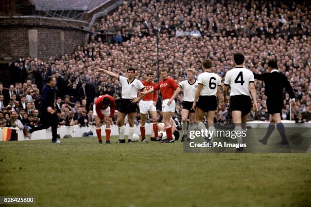 Referee Concetto Lo Bello sends off USSR's Igor Chislenko after he retaliated against West Germany's Siggi Held West Germany's Lothar Emmerich helps...