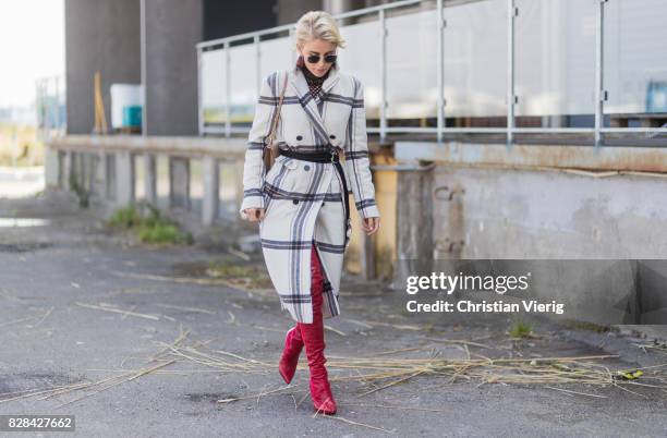 Caro Daur wearing a plaid coat By Malene Birger, Dolce & Gabbana bag, red boots outside By Malene Birger on August 09, 2017 in Copenhagen, Denmark.