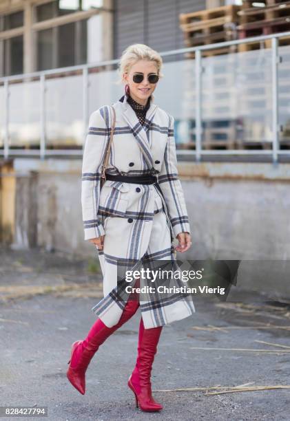 Caro Daur wearing a plaid coat By Malene Birger, Dolce & Gabbana bag, red boots outside By Malene Birger on August 09, 2017 in Copenhagen, Denmark.