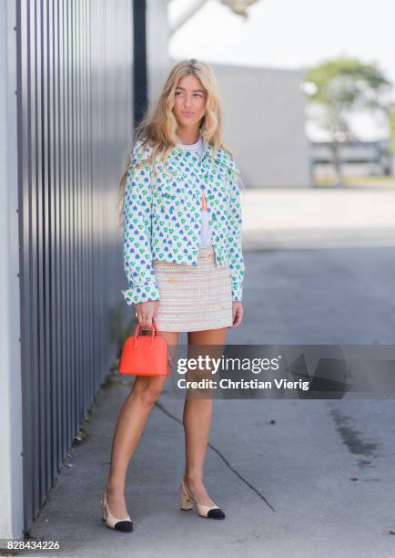 Emili Sindlev wearing a red Prada bag, turquoise blazer, mini skirt, Chanel shoes outside By Malene Birger on August 09, 2017 in Copenhagen, Denmark.