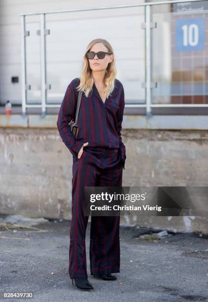 Jessie Bush wearing a striped suit outside By Malene Birger on August 09, 2017 in Copenhagen, Denmark.