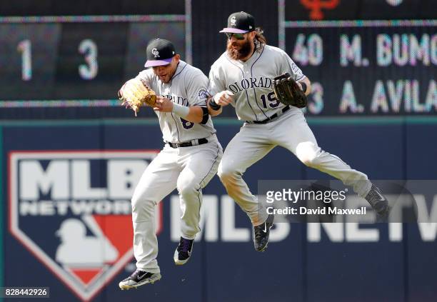 Charlie Blackmon and Gerardo Parra of the Colorado Rockies celebrate after defeating the Cleveland Indians in 12 innings at Progressive Field on...