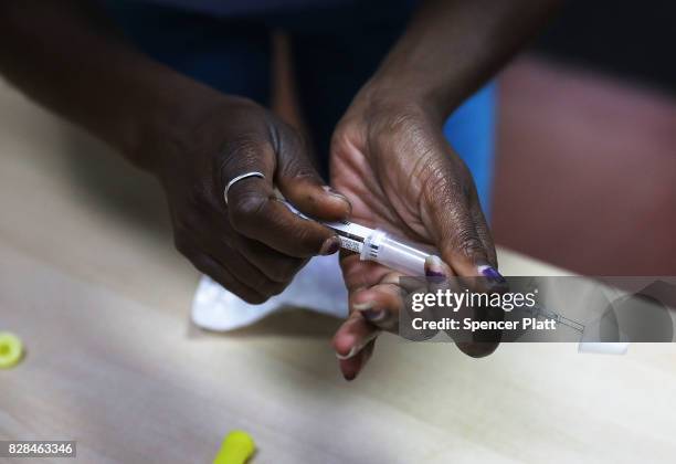 Students learn to put together a Naloxone spray gun in a class on opioid overdose prevention held by non-profit Positive Health Project on August 9,...