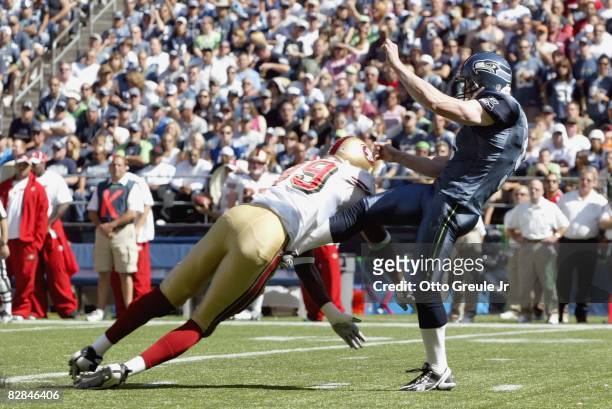 Jon Ryan of the Seattle Seahawks has the punt blocked by Manny Lawson of the San Francisco 49ers on September 14, 2008 at Qwest Field in Seattle...