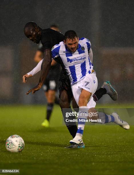 Christopher Samba of Aston Villa challenges Drey Wright of Colchester during the Carabao Cup First Round match between Colchester United and Aston...