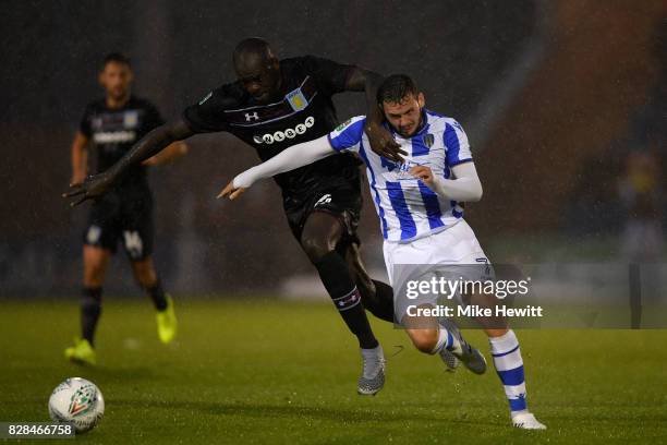 Christopher Samba of Aston Villa challenges Drey Wright of Colchester during the Carabao Cup First Round match between Colchester United and Aston...