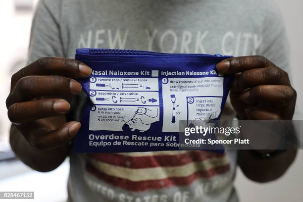 Derrick, a participant in a class on opioid overdose prevention held by non-profit Positive Health Project, holds up an overdose rescue kit after...