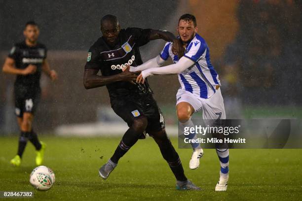 Christopher Samba of Aston Villa challenges Drey Wright of Colchester during the Carabao Cup First Round match between Colchester United and Aston...