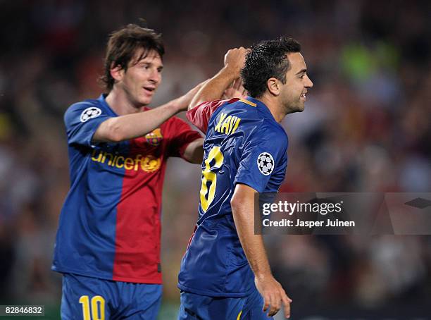 Xavi Hernandez of Barcelona celebrates his goal with teammate Lionel Messi during the UEFA Champions League Group C match between Barcelona and...