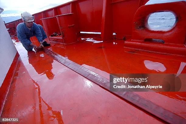 Jo Cedar crew member is placing straight a fire hose during a fire drill exercise, on July 16 in France. Each time a fake fire is created by the...