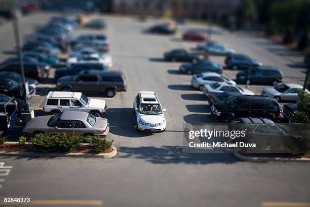 car in parking lot pulling out - car leaving stock pictures, royalty-free photos & images