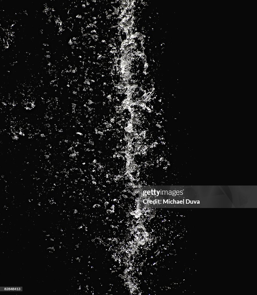 Studio shot of water falling and splashing