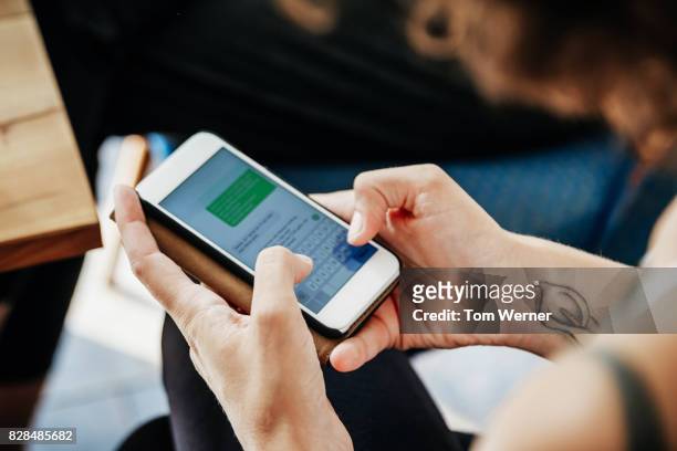 close up of woman messaging friends using smartphone - text ストックフォトと画像