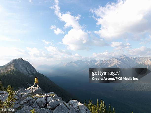 teenage boy walks to rocky crest above valley - wonderlust2015 stock pictures, royalty-free photos & images
