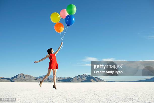balloons carrying off young woman - balloon ストックフォトと画像