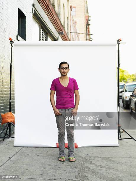 man on standing on sidewalk, portrait - backdrop 個照片及圖片檔