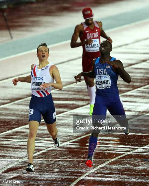 Karsten Warholm of Norway and Kerron Clement of the United States react after crossing the finish line in the Men's 400 metres hurdles during day six...