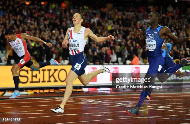 Karsten Warholm of Norway and Kerron Clement of the United States cross the finish line in the Men's 400 metres hurdles during day six of the 16th...