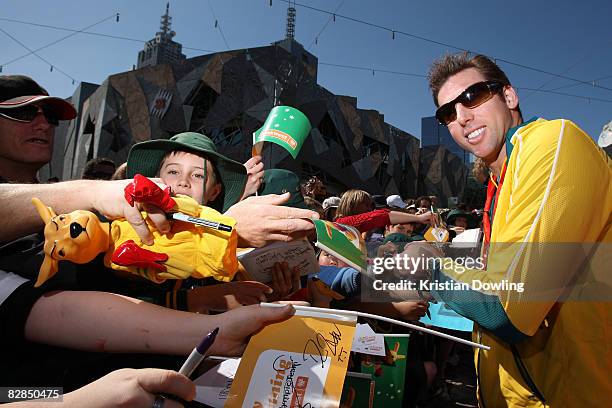 Swimmer Grant Hackett signs autographs for fans during a welcome home parade for the Beijing 2008 Olympic Athletes at Federation Square on September...