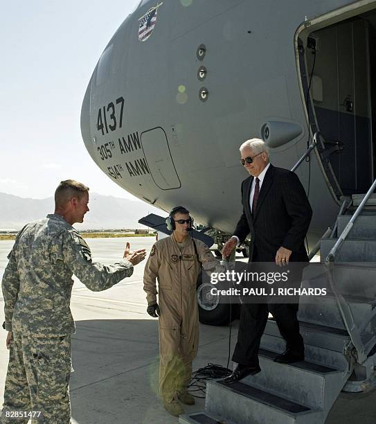 Secretary of Defense Robert Gates steps down from a US Air-Force C-17 as US Army Major General Jeffrey Schloesser moves forward to greet him during...