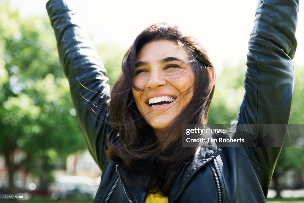 Happy woman with arms in the air