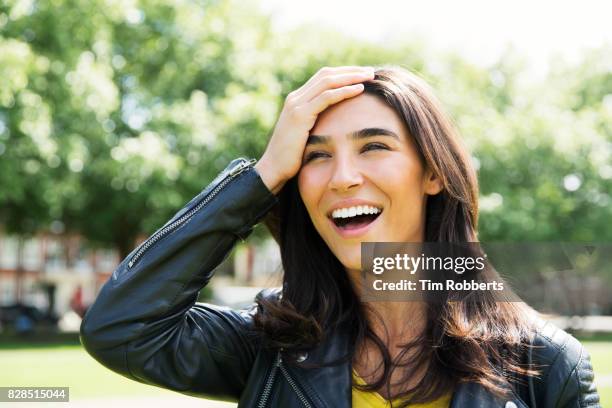 woman with hand on head - erinnerung stock-fotos und bilder