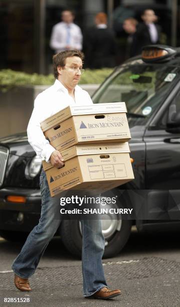 Man carries boxes as he leaves the Lehman Brothers European Headquarters building in Canary Wharf in east London on September 16, 2008. World...