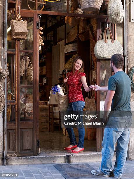 girl tries to pull boyfriend into shop - palma mallorca stock pictures, royalty-free photos & images