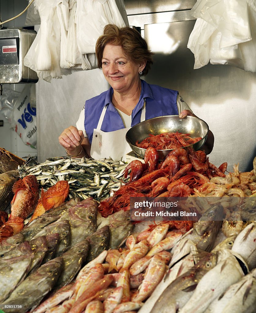 Woman sells fish at stand