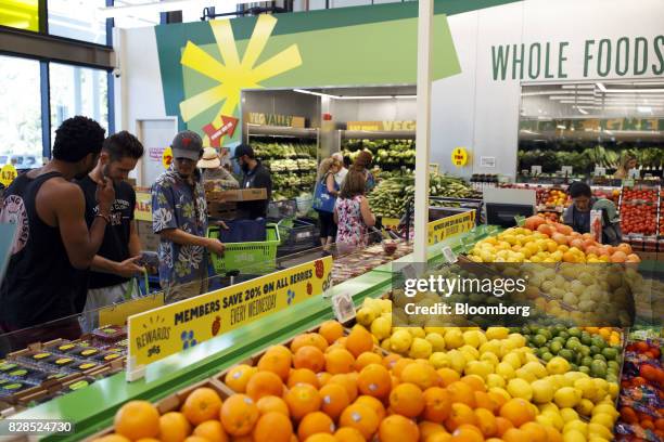 Customers browse produce during the grand opening of a Whole Foods Market 365 location in Santa Monica, California, U.S., on Wednesday, Aug. 9, 2017....