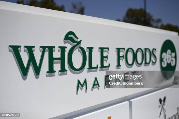 Signage is displayed outside of a Whole Foods Market 365 location during the grand opening in Santa Monica, California, U.S., on Wednesday, Aug. 9,...