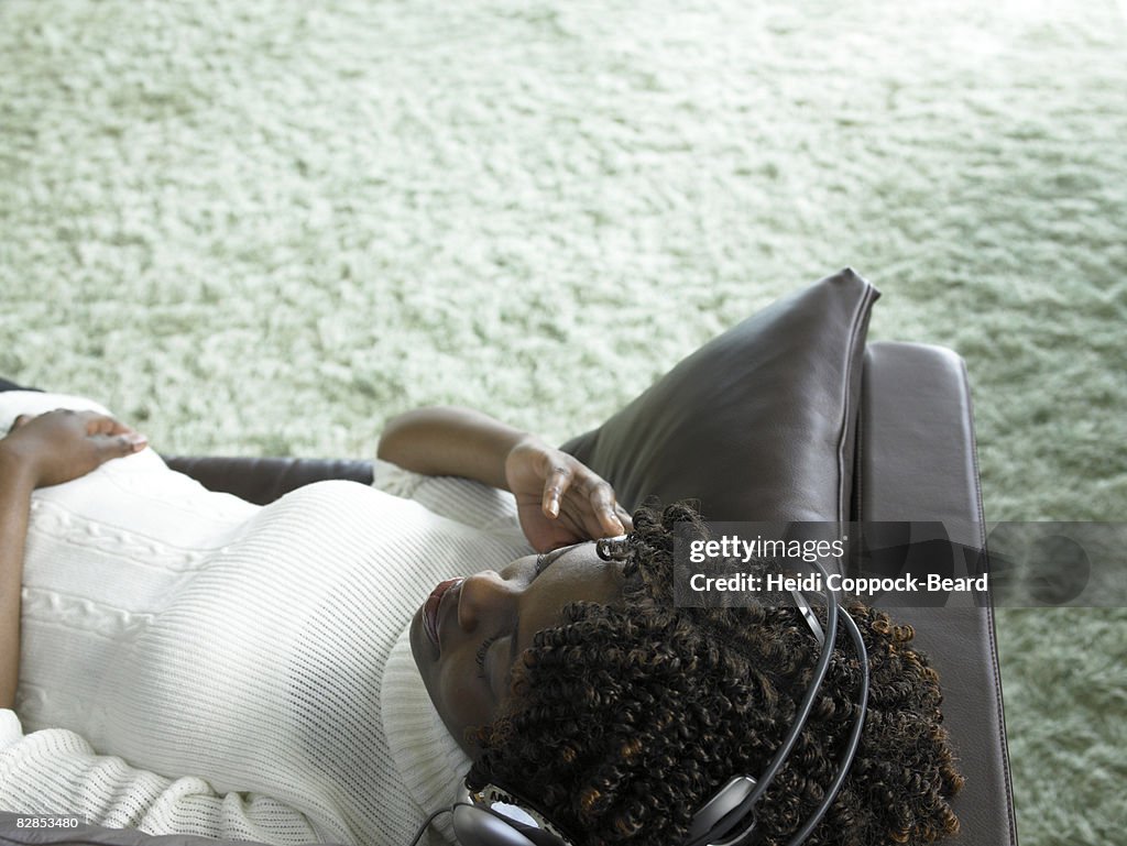 Young Black woman relaxing listening to headphones