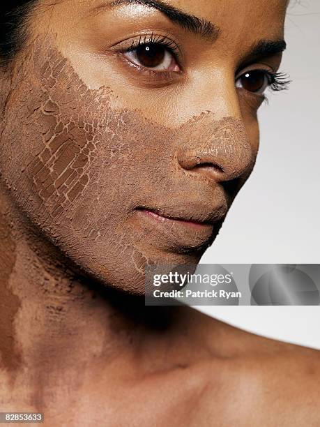 woman with mud mask - fango stock-fotos und bilder