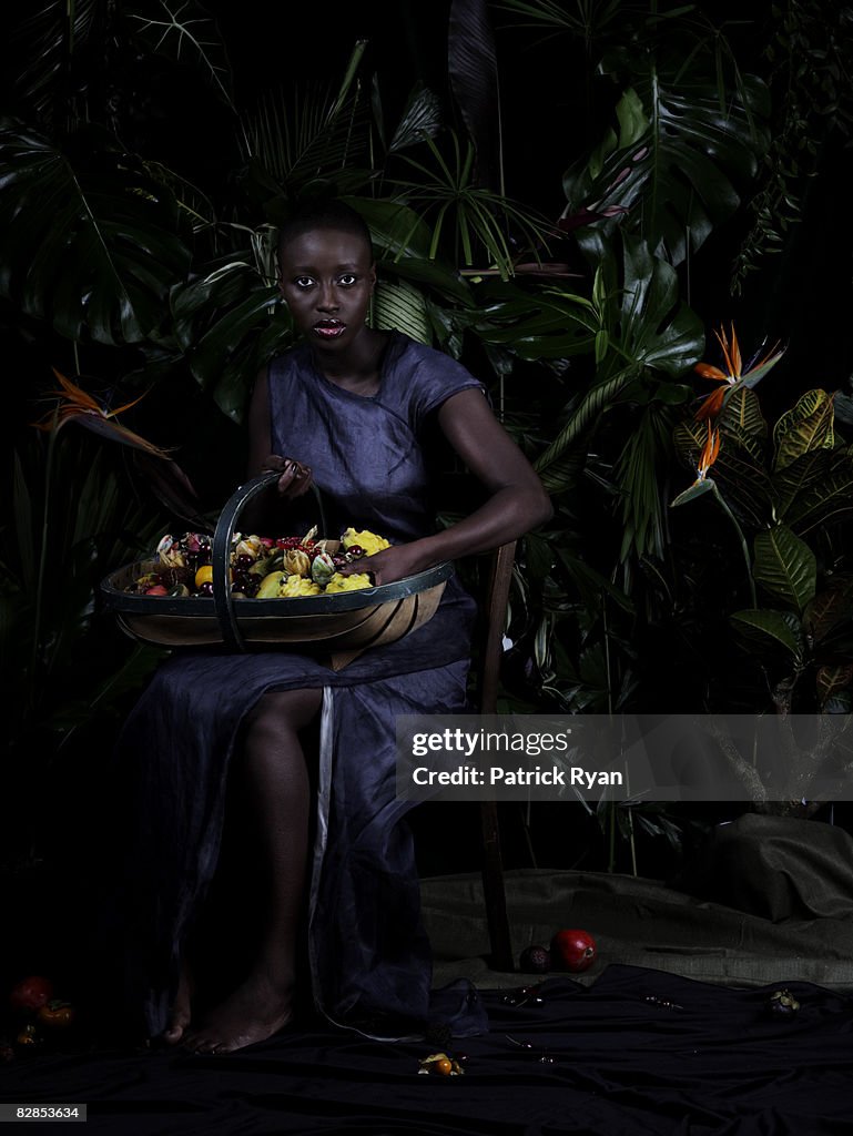 Black woman with large basket of exotic fruit