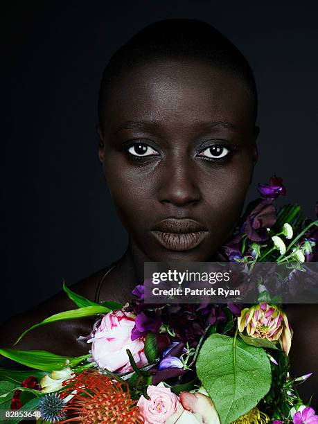 black woman with garland of flowers - newcraft stock-fotos und bilder