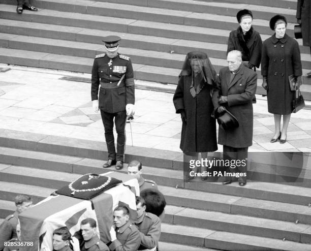 Lady Churchill places her arm in that of her son, Randolph Churchill, as they walked slowly down the steps of St Paul's Cathedral behind the coffin...