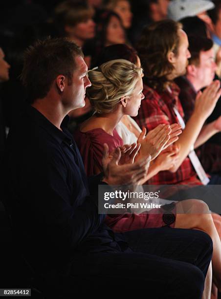 New Zealand All Blacks player Ali Williams and Casey Green watch designs on the catwalk by Trelise Cooper on the second day of Air New Zealand...