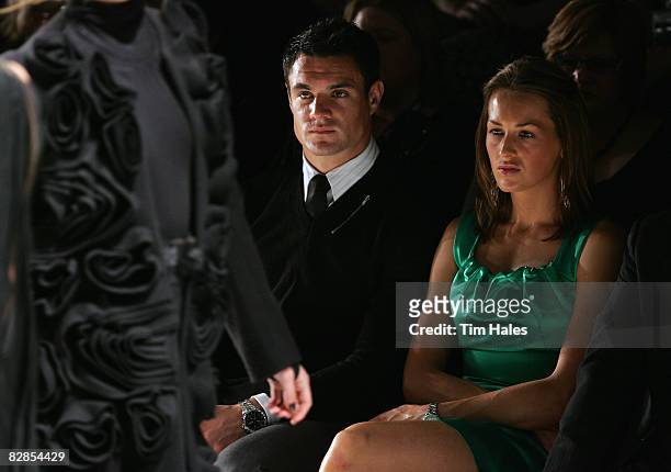 New Zealand All Blacks player Dan Carter and Honor Dillon watch designs on the catwalk by Trelise Cooper on the second day of Air New Zealand Fashion...
