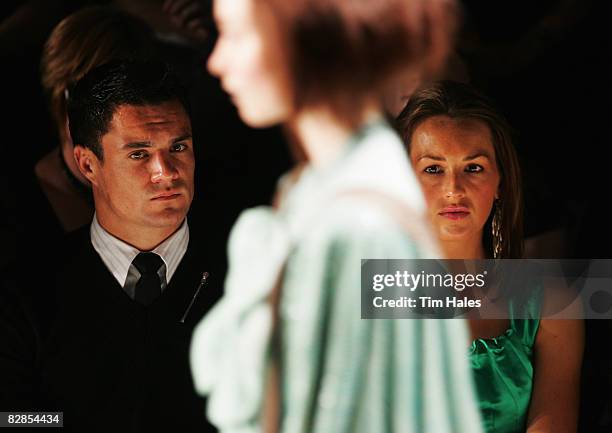 New Zealand All Blacks player Dan Carter and Honor Dillon watch designs on the catwalk by Trelise Cooper on the second day of Air New Zealand Fashion...