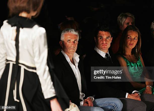 Air New Zealand CEO Rob Fyffe, New Zealand All Blacks player Dan Carter and Honor Dillon watch designs on the catwalk by Trelise Cooper on the second...