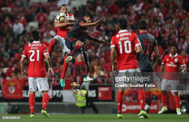 Benfica midfielder Ljubomir Fejsa from Serbia with SC Braga forward Rui Fonte from Portugal and SC Braga forward Ahmed Hassan from Egypt in action...