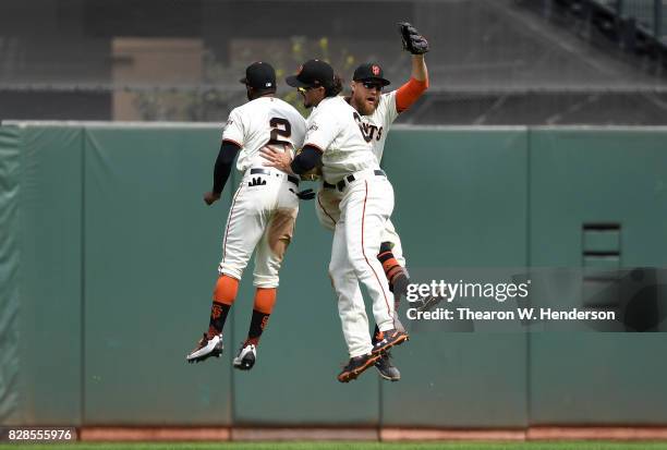 Denard Span, Jarrett Parker and Hunter Pence of the San Francisco Giants celebrates defeating the Chicago Cubs 3-1 at AT&T Park on August 9, 2017 in...