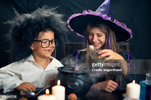 halloween kids playing with potions - cauldron stock pictures, royalty-free photos & images