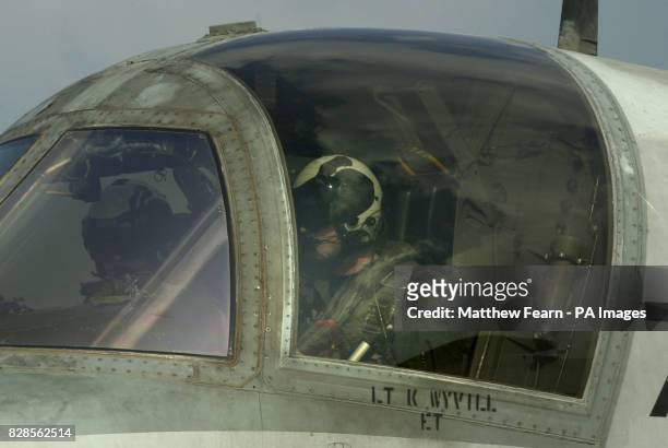 British-born US Navy Lieutenant Karl Wyvill from Hull, East Yorkshire sits in the cockpit of his Viking refuelling plane on the USS Abraham Lincoln...