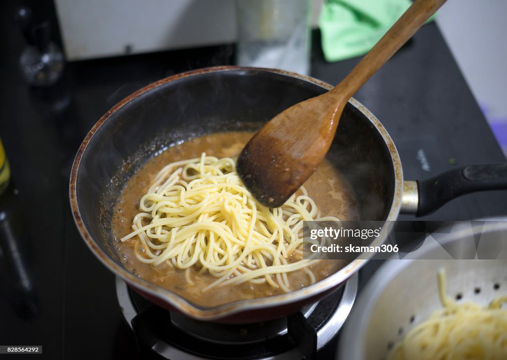 Boiled water and spaghetti noodle for cooking italian pasta