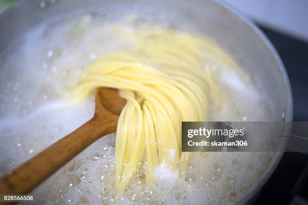 boiled water and spaghetti noodle for cooking italian pasta - boiling stock pictures, royalty-free photos & images